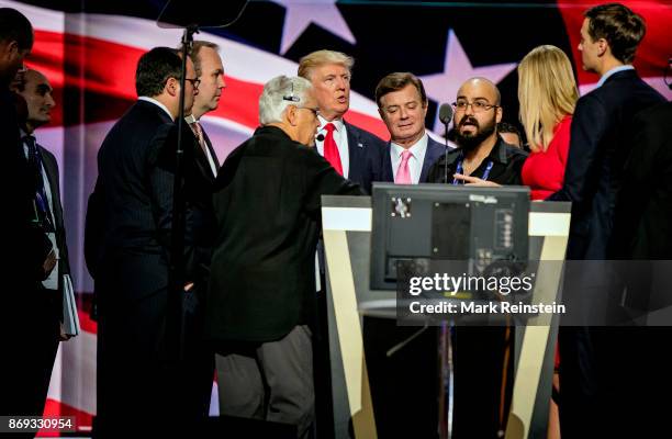 American real estate developer and presidential candidate Donald Trump and others on stage during the sound check on the final day of the Republican...