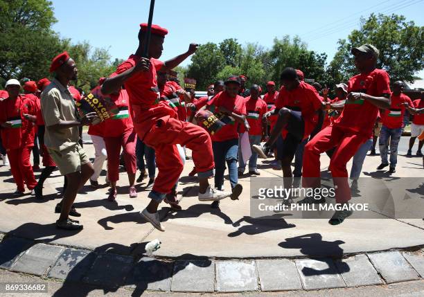 South African opposition Party Economic Freedom Fighters members dance during a demonstration to express their solidarity with the Palestiniansin...