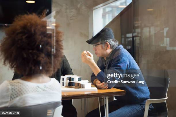 senior professional discussing in modern meeting room - south korea office stock pictures, royalty-free photos & images