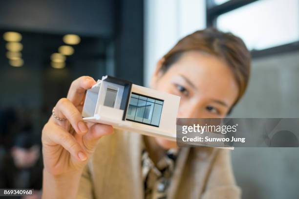 portrait of creative professional holding architectural model - architect stock pictures, royalty-free photos & images