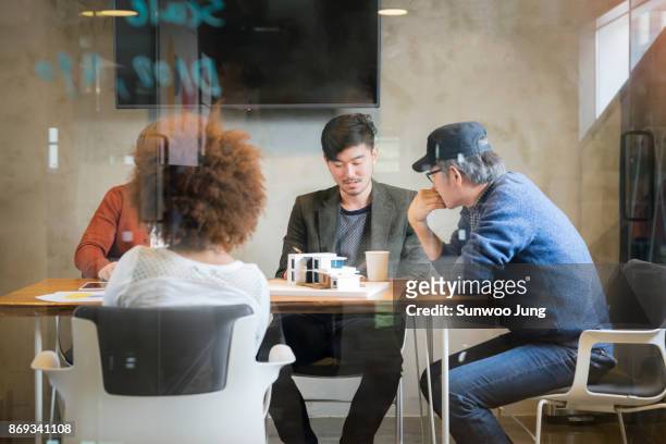 senior professional discussing in modern meeting room - south korea business stock pictures, royalty-free photos & images