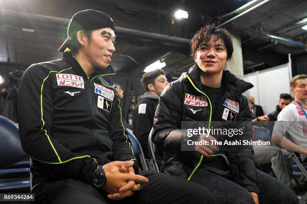 Takahito Mura and Shoma Uno of Japan talk after competing in the Men's Singles Short Program during day one of the ISU Grand Prix of Figure Skating...