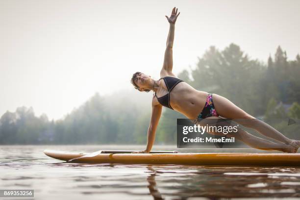 sup yoga - the side plank pose - vasisthasana - side plank pose stock pictures, royalty-free photos & images