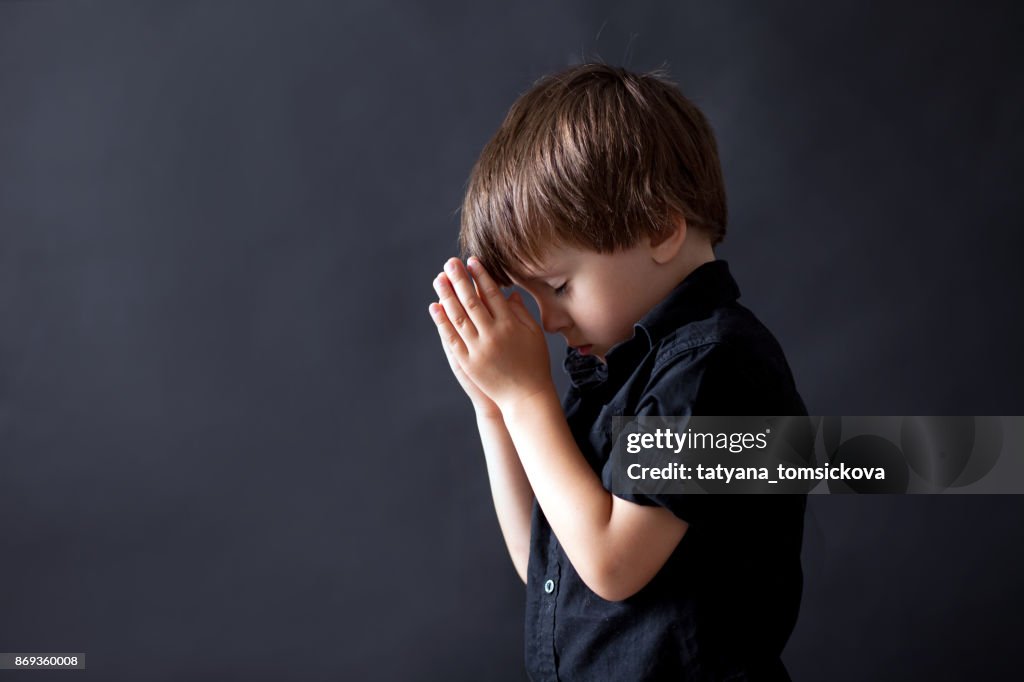 Little boy praying, child praying, isolated background