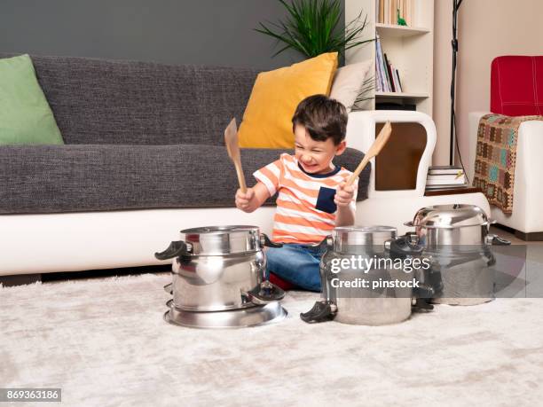 cute child is playing cooking pans like a drums - hitting drum stock pictures, royalty-free photos & images