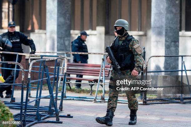 Macedonian police officer secures the court during the trial of 37 men accused of terror charges over a shootout with police, in Skopje on November...