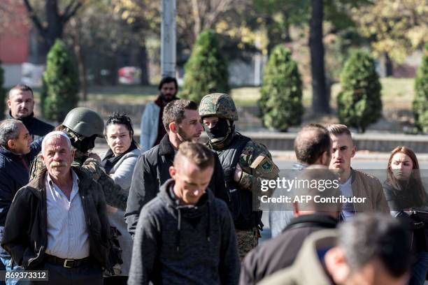 Macedonian police officer secures the court during the trial of 37 men accused of terror charges over a shootout with police, in Skopje on November...