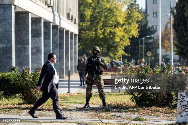 Macedonian police officer secures the court during the trial of 37 men accused of terror charges over a shootout with police, in Skopje on November...