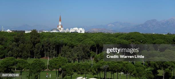 Players walk down the 16th hole during the first round of the Turkish Airlines Open at the Regnum Carya Golf & Spa Resort on November 2, 2017 in...