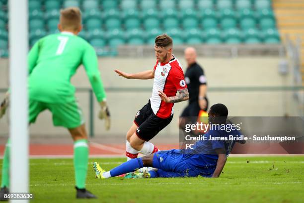 Callum Slattery of Southampton FC goes down after a tackle from Nathan Mavilla during the PL2 match between Southampton FC U23's and Cardiff City on...