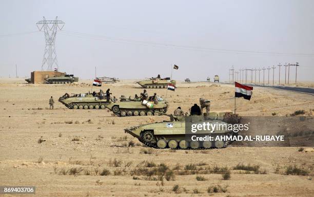 Iraqi forces and members of the Hashed al-Shaabi advance towards the city of al-Qaim, in western Anbar province, on the Syrian border as they fight...