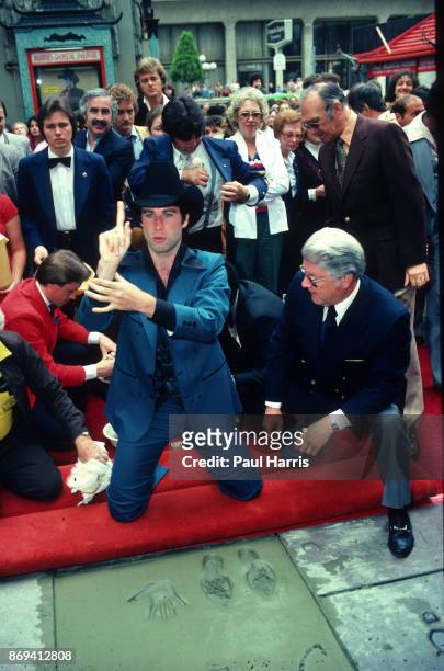 Actor John Travolta gets a Hollywood Star, footprints and hand prints in concrete outside Manns Chinese Theatre. The star was for his roll as Buford...