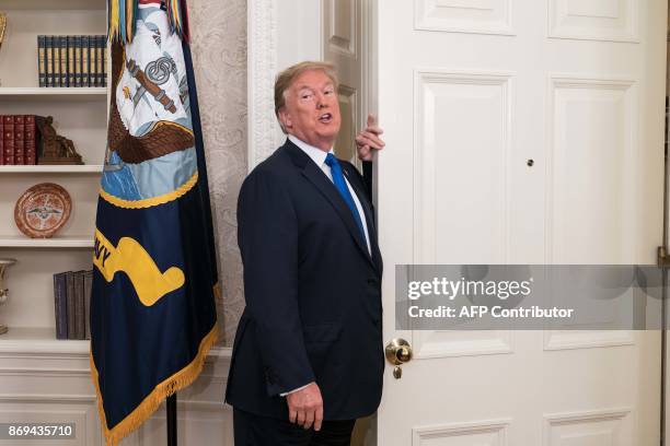 President Donald Trump leaves after he announced that Broadcom woud be moving back to the US in the Oval Office at the White House in Washington, DC,...