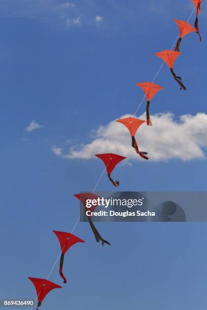 train of kites in the blue sky - benjamin franklin kite stock pictures, royalty-free photos & images