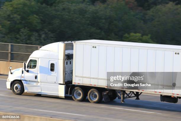 side view of a moving semi truck on a highway bridge - elevator bridge ストックフォトと画像