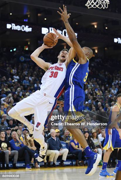 David West of the Golden State Warriors goes up to block the shot of Jon Leuer of the Detroit Pistons during an NBA basketball game at ORACLE Arena...