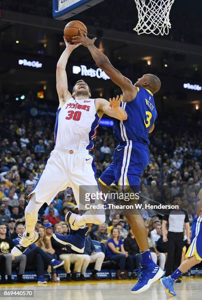 David West of the Golden State Warriors goes up to block the shot of Jon Leuer of the Detroit Pistons during an NBA basketball game at ORACLE Arena...