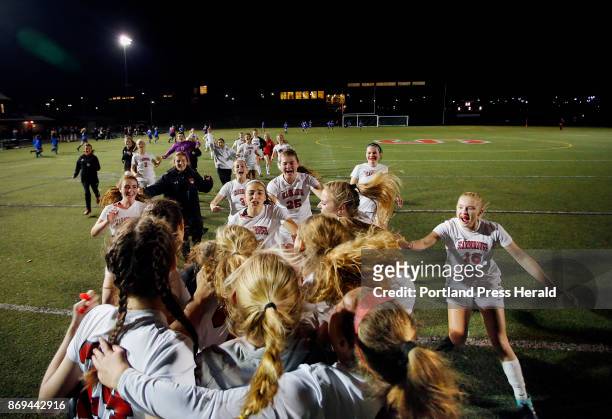 Scarborough vs Kennebunk Class A South championship game. Scarborough teammates rush the field to celebrate around keeper Nikki Young who came in to...