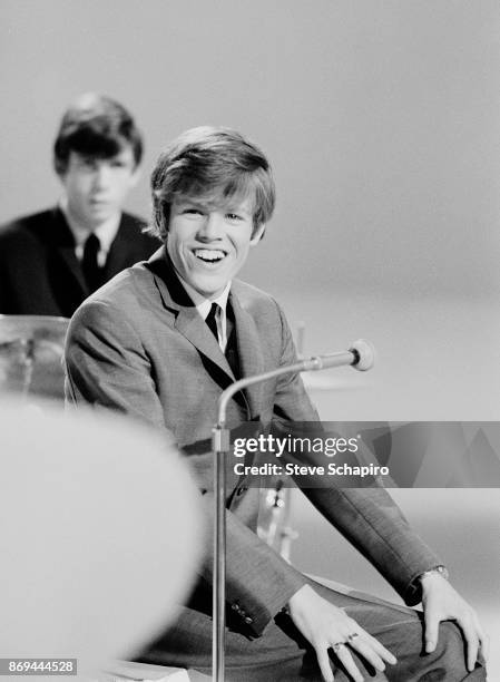 View of English musician Peter Noone, of the group Herman's Hermits, as he laughs, New York, New York, 1965. Visible behind him is fellow bandmate...