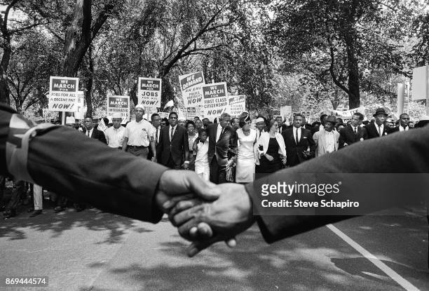 View of hands held together, and the front line of demonstrators during the March on Washington for Jobs and Freedom, Washington DC, August 28, 1963....
