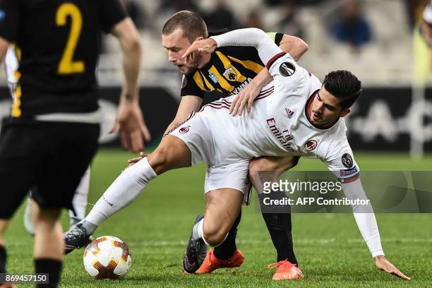 Milan's Andre Silva vies for the ball with AEK's Jakob Johansson during the UEFA Europa League Group D football match between AEK Athens and AC Milan...