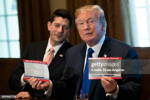 Speaker of the House Paul Ryan looks on as President Donald Trump speaks about tax reform legislation in the Cabinet Room at the White House,...