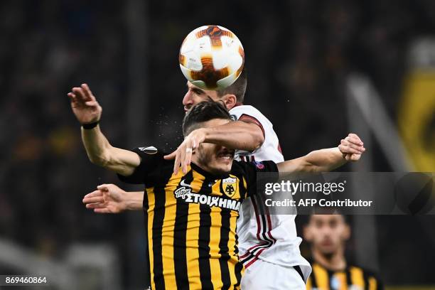 Milan's Fabio Borini vies for the ball with AEK's Helder Lopes during the UEFA Europa League Group D football match between AEK Athens and AC Milan...