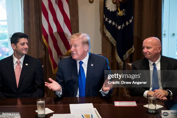 Flanked by Speaker of the House Paul Ryan and House Ways and Means Committee chairman Rep. Kevin Brady , President Donald Trump speaks about tax...