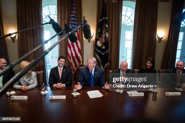 Flanked by Speaker of the House Paul Ryan and House Ways and Means Committee chairman Rep. Kevin Brady , President Donald Trump speaks about tax...