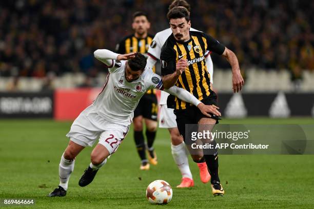 Milan's Mateo Musacchio vies for the ball with AEK's Lazaros Christodoulopoulos during the UEFA Europa League Group D football match between AEK...
