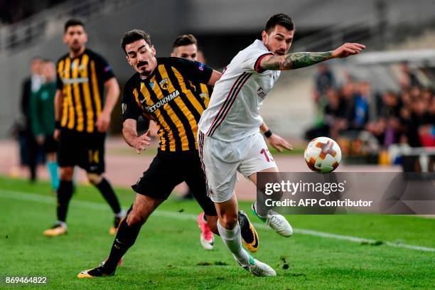 Milan's Alessio Romagnoli vies for the ball with AEK's Lazaros Christodoulopoulos during the UEFA Europa League Group D football match between AEK...