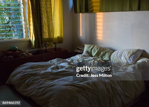 Empty unmade bed with sunlight Empty unmade bed with sunlight
