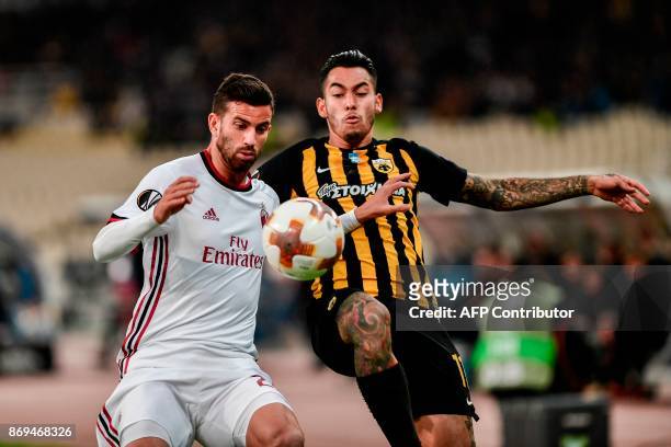 Milan's Mateo Musacchio vies for the ball with AEK's Sergio Araujo during the UEFA Europa League Group D football match between AEK Athens and AC...