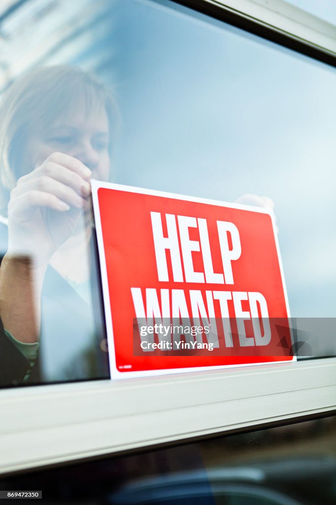 Help Wanted Sign on Retail Display Window for Employment Job Available