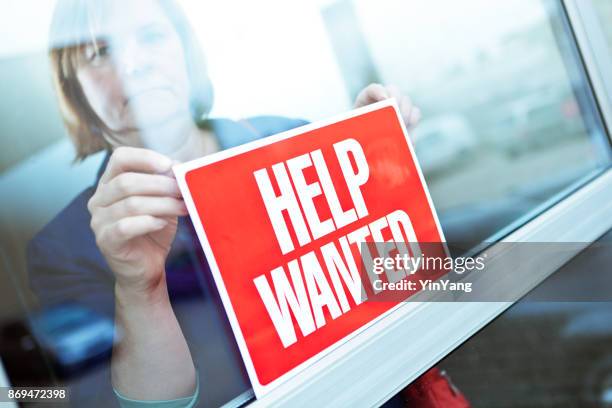 help wanted sign on retail display window for employment job available - help wanted sign stock pictures, royalty-free photos & images