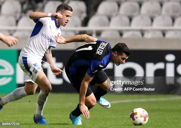 Atalanta's Remo Freuler vies for the ball with Apollon's Esteban Sachetti during the UEFA Europa League football match Apollon Limassol versus...