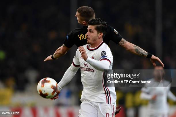 Milan's Andre Silva vies for the ball with AEK's Ognjen Vranjes during the UEFA Europa League Group D football match between AEK Athens and AC Milan...