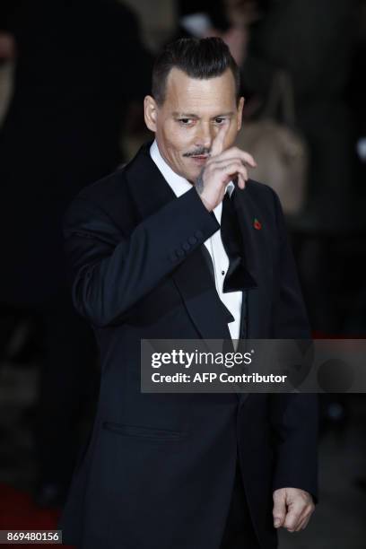 Actor Johnny Depp poses upon arrival to attend the world premiere of the film 'Murder on the Orient Express' at the Royal Albert Hall in west London...