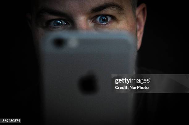 Man is seen using an iPhone on November 2, 2017. Concerns have been raised about Apple's new iPhone X and it's front facing camera with face...