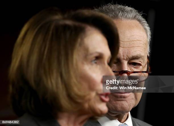 Sennate Minority Leader Chuck Schumer listens as House Minority Leader Nancy Pelosi speaks during a press conference where congressional Democrats...