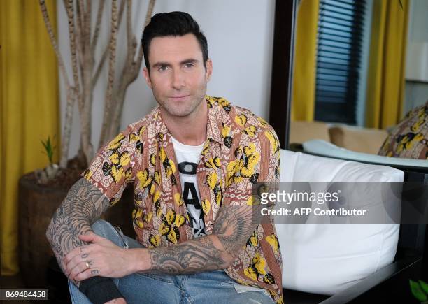 Adam Levine of Maroon 5 poses for pictures in New York on October 31, 2017. Tensions may be mounting dangerously around the world but for Maroon 5,...