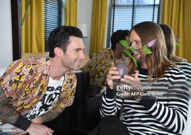 Adam Levine and James Valentine of Maroon 5 pose for pictures in New York on October 31, 2017. Tensions may be mounting dangerously around the world...