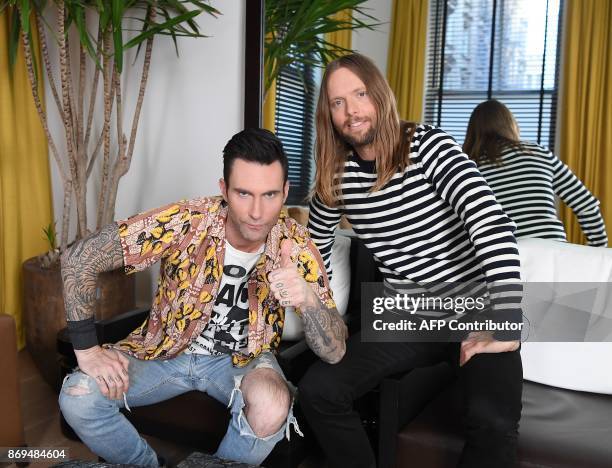 Adam Levine and James Valentine of Maroon 5 pose for pictures in New York on October 31, 2017. Tensions may be mounting dangerously around the world...