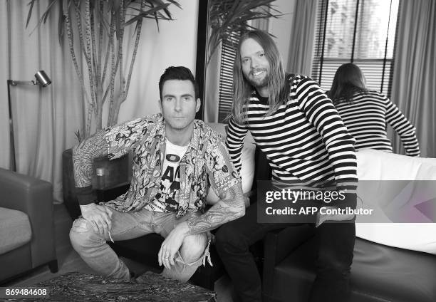 Adam Levine and James Valentine of Maroon 5 pose for pictures in New York on October 31, 2017. Tensions may be mounting dangerously around the world...