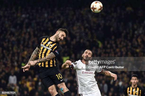 Milan's Leonardo Bonucci fights for the ball with AEK's Sergio Araujo during the UEFA Europa League Group D football match between AEK Athens and AC...