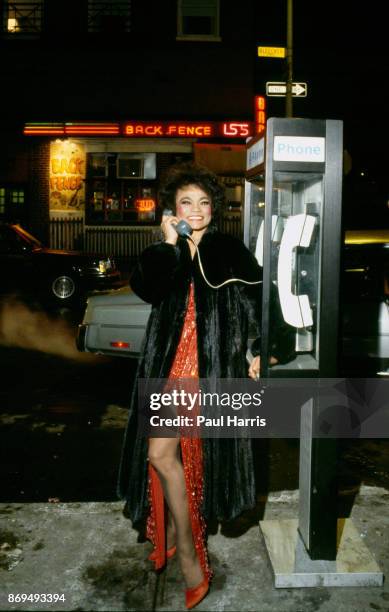 Eartha Kitt , standing on a Manhattan street corner makes a phone call to friends in Los Angeles before flying there, December 12 Manhattan, New York