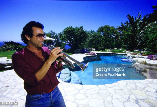 Herb Alpert 47 founder of the Tijuana Brass and A&M records plays a trumpet in the garden of his Malibu home which is on a cliff overlooking the...