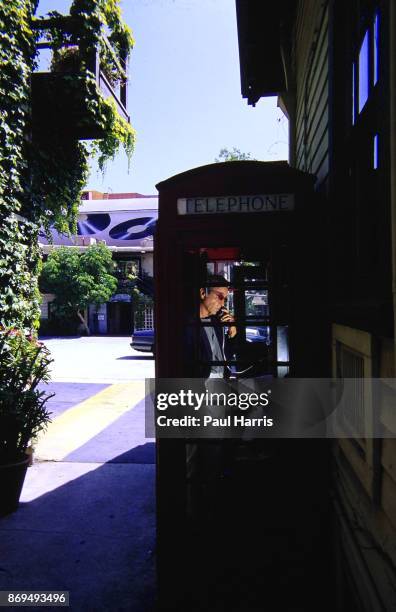 Herb Alpert 47 founder of the Tijuana Brass and A&M records , make a phone call from an English Telephone box in the garden of the Malibu home he has...