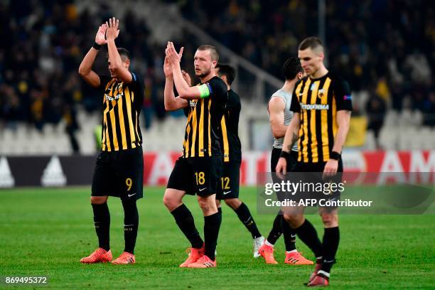 S players applaud as they acknowledge their fans after the UEFA Europa League Group D football match between AEK Athens and AC Milan at the OAKA...