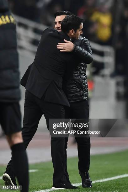 Milan's coach Vincenzo Montella hugs AEK's coach Manolo Jimenez after the UEFA Europa League Group D football match between AEK Athens and AC Milan...